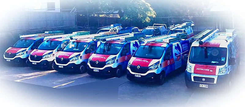 A line of Strybos & Sons Electrical vans in red and blue livery